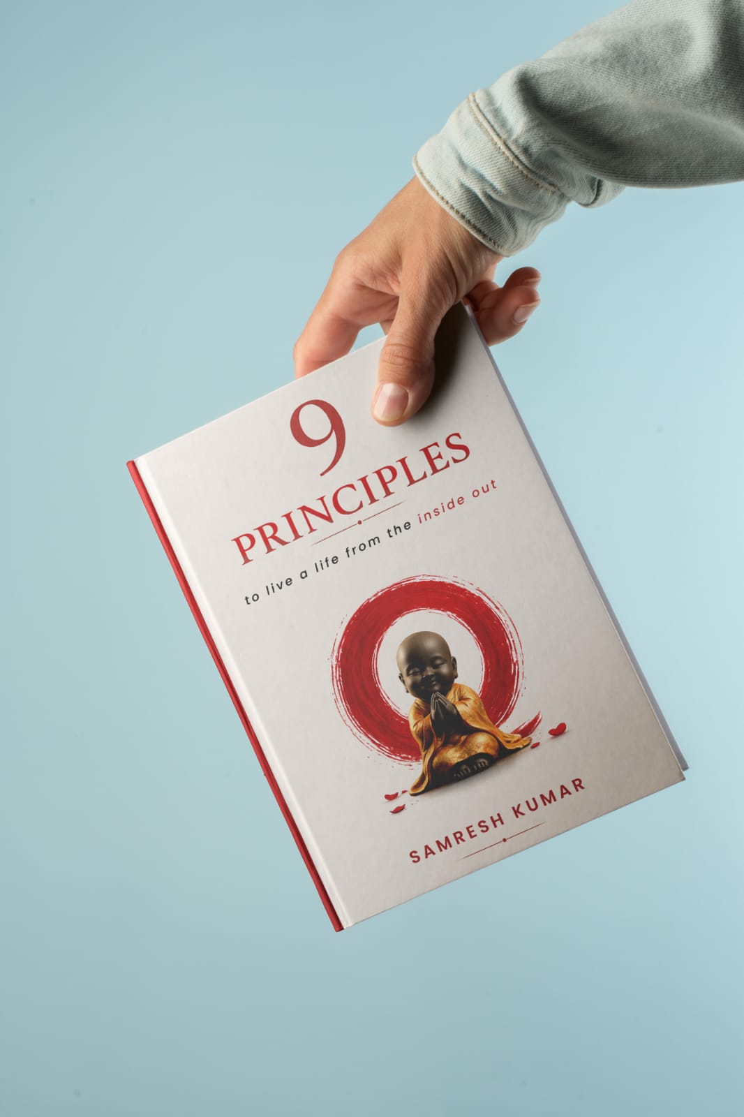 9 Principles book held in hands